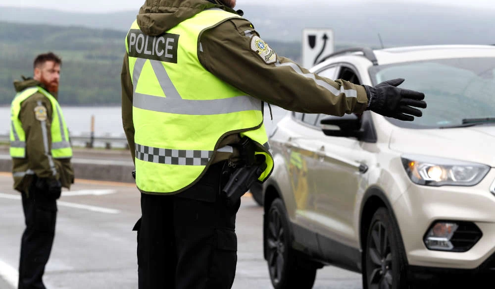 Canadian police check a car in La Malbaie. (REUTERS)