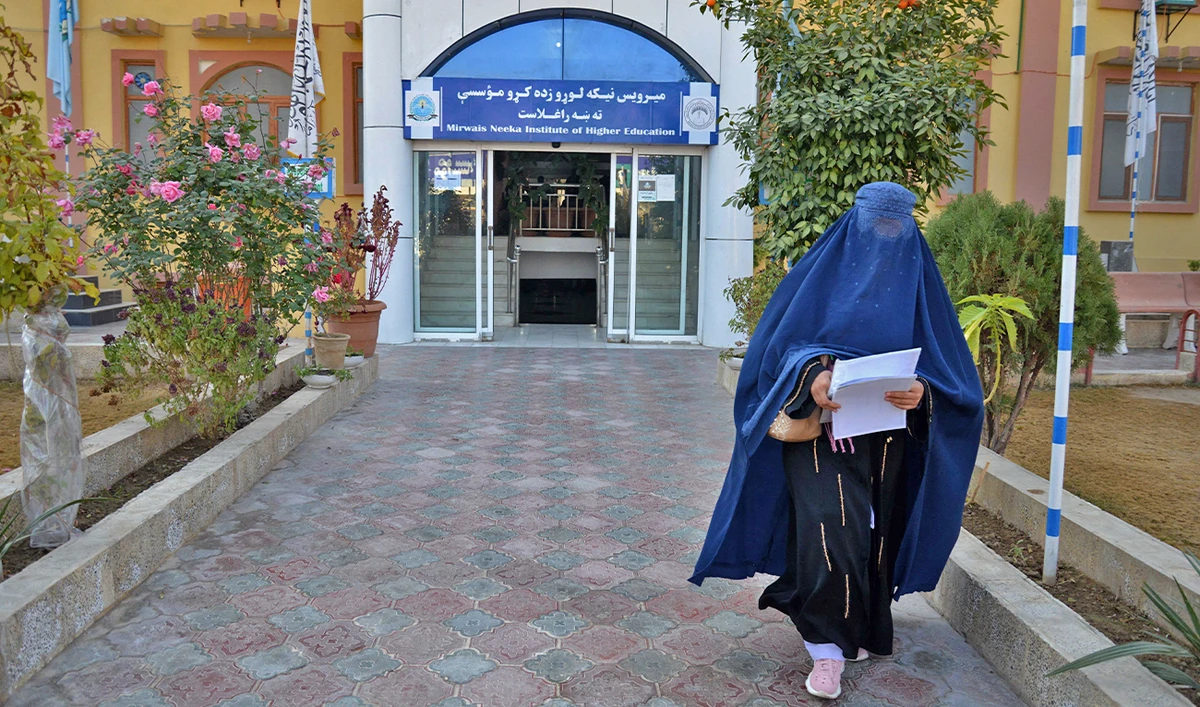 A female university Student walks in front of a university in Kandahar Province of Afghanistan on December 21, 2022. (AFP)