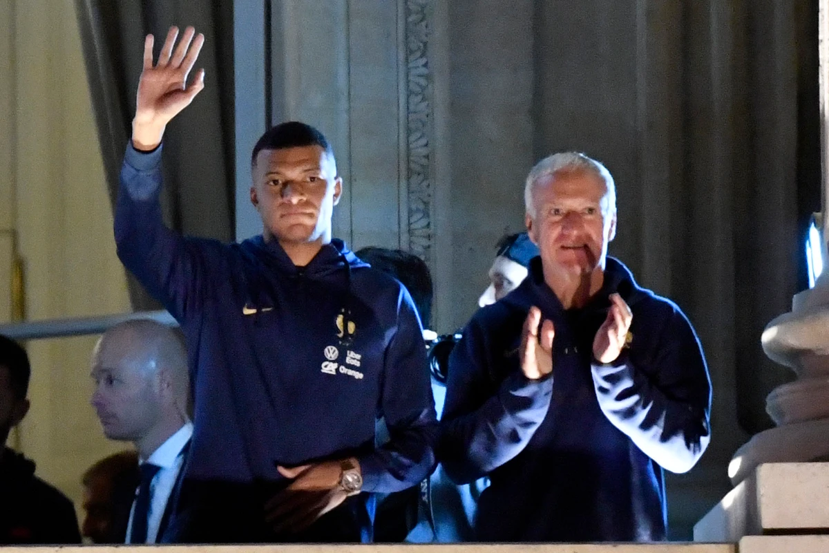 France's forward Kylian Mbappe (L) and France's coach Didier Deschamps greet supporters at the Hotel de Crillon, a day after the Qatar 2022 World Cup final match against Argentina. (File/AFP)