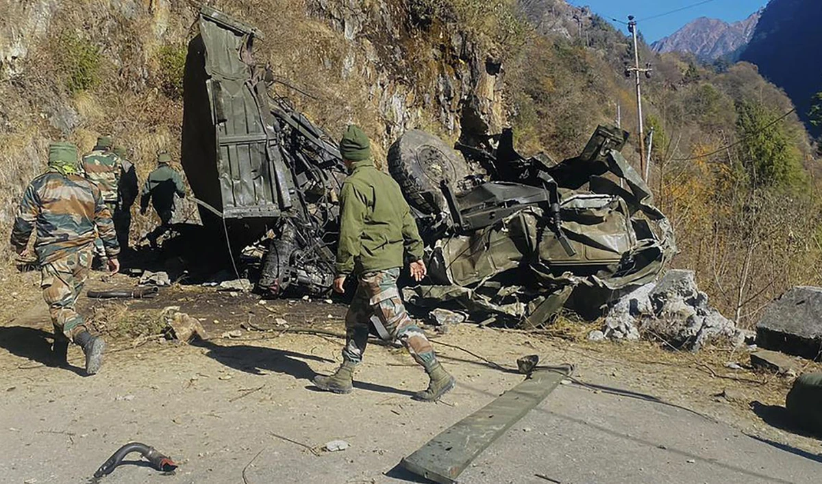 Indian army personnel seen near the wreckage of an army truck which skidded down a steep mountain slope and crashed at Zema in North Sikkim, India, on December 23, 2022.(Photo courtesy: Press Trust of India)