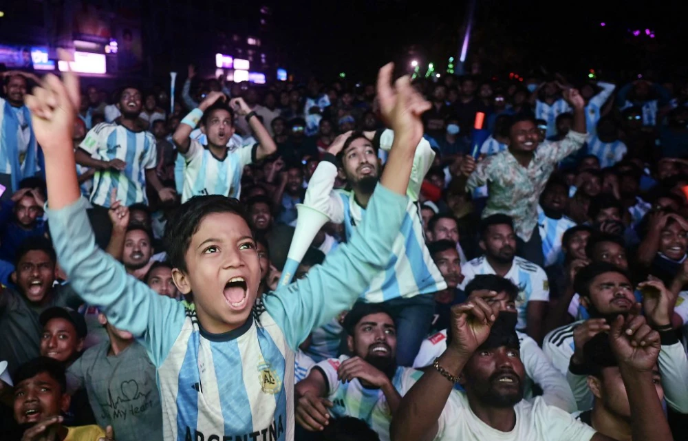 Bangladeshi football fans react as they watch the Qatar 2022 World Cup Group C football match between Poland and Argentina on a big screen in Dhaka on Dec. 1, 2022. (AFP)