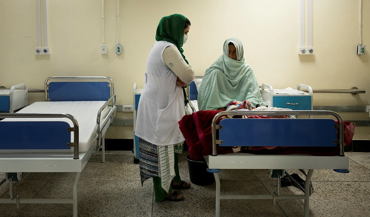In this picture taken on March 28, 2021, a nurse tends to a mother and her infant at the therapeutic feeding unit of NGO "Action contre La Faim" in Lashkar Gah, Helmand province. (AFP/File)