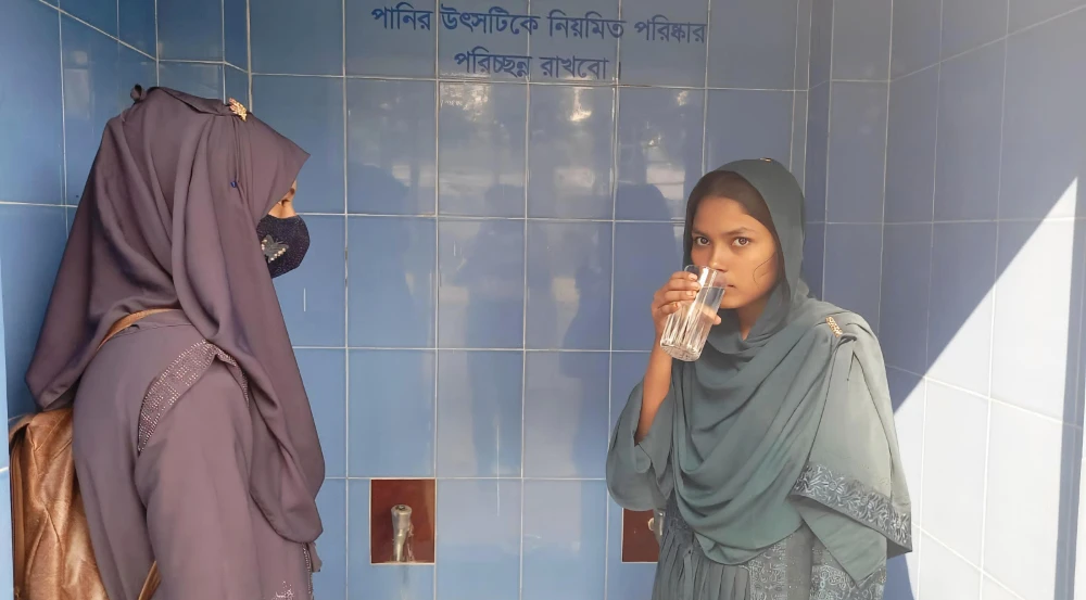 Students drink filtered water at a rain collection facility at Gabura GlM Secondary School in Shyamnagar, Satkhira district, Bangladesh. (AN Photo by Shahinoor Islam)