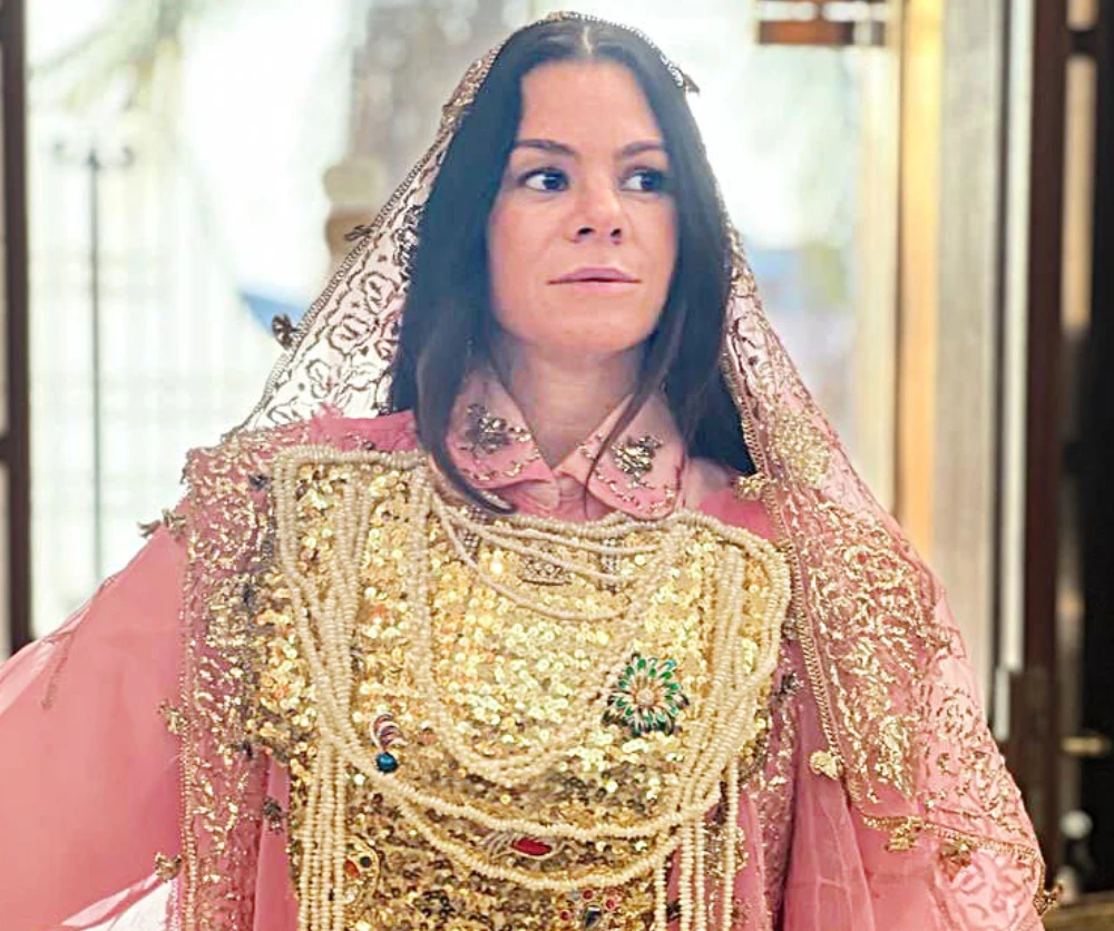 Nasiba Hafiz, board member of AlOula, dressed in a traditional Hijazi costume.ed in a traditional Hijazi costume.