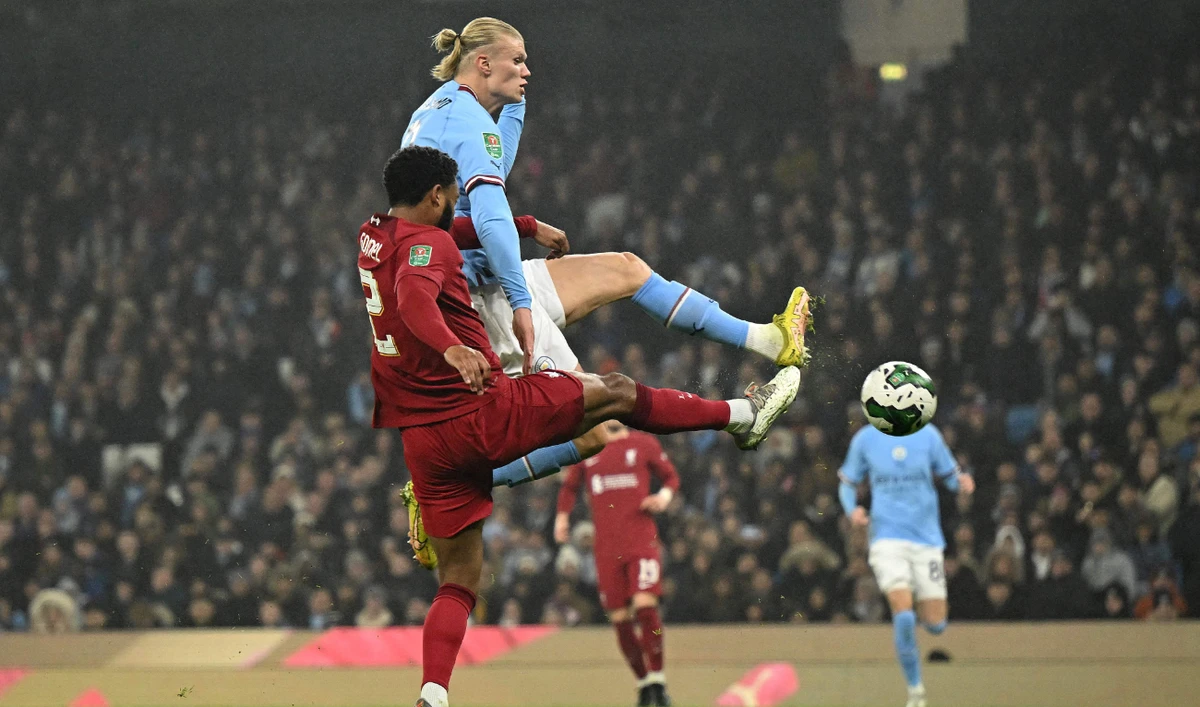 Manchester City's Norwegian striker Erling Haaland (R) scores the opening goal during their English League Cup fourth round football match against Liverpool at the Etihad stadium on Dec. 22, 2022. (AFP)
