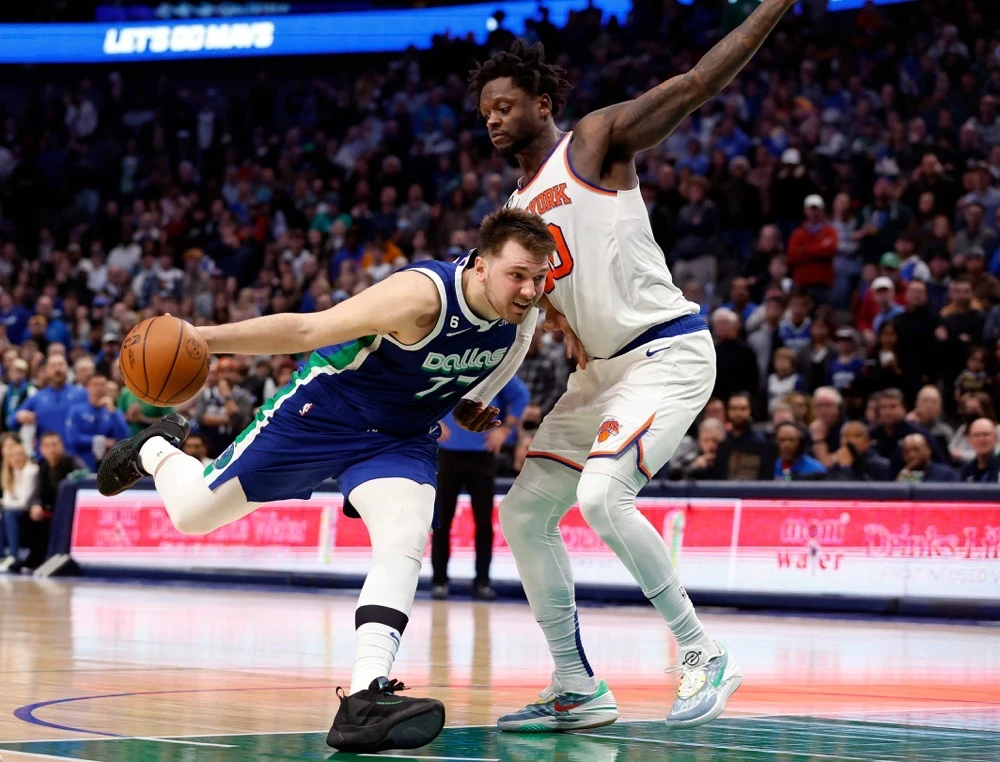 Luka Doncic of the Dallas Mavericks drives around Julius Randle of the New York Knicks in overtime of their NBA game at American Airlines Center on Tuesday in Dallas, Texas. (AFP)