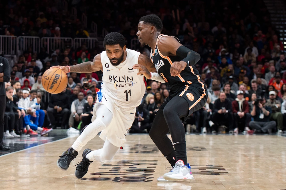Brooklyn Nets guard Kyrie Irving drives to the basket against Atlanta Hawks guard Aaron Holiday during the second half of an NBA basketball game Wednesday in Atlanta. (AP)