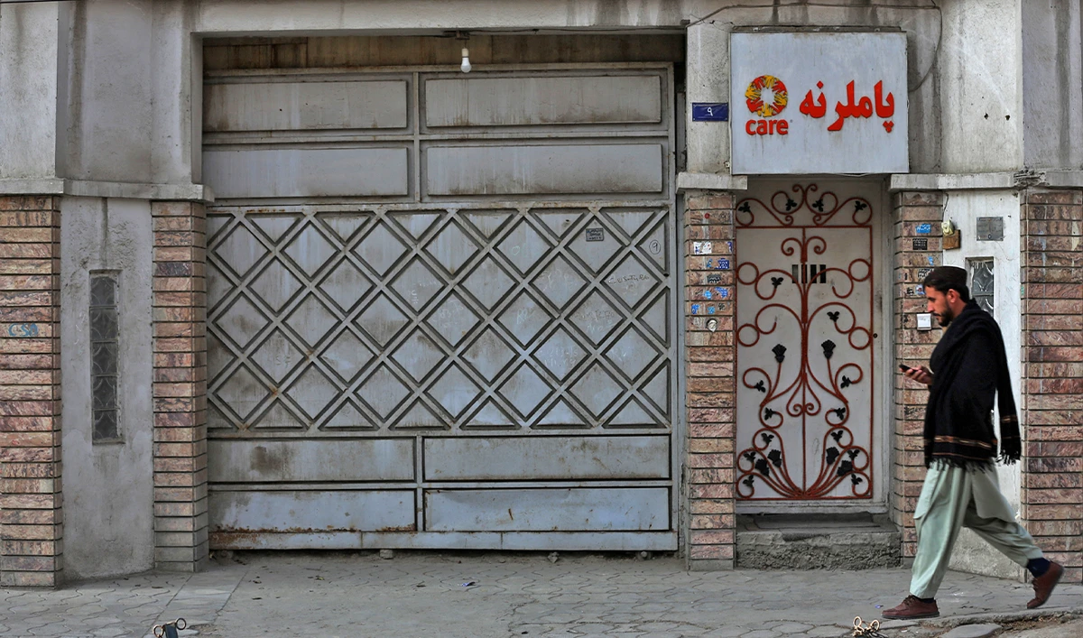 An Afghan man walks past the office of a foreign aid group 'Care' in downtown Kabul, Afghanistan, on December 26, 2022. (AFP)