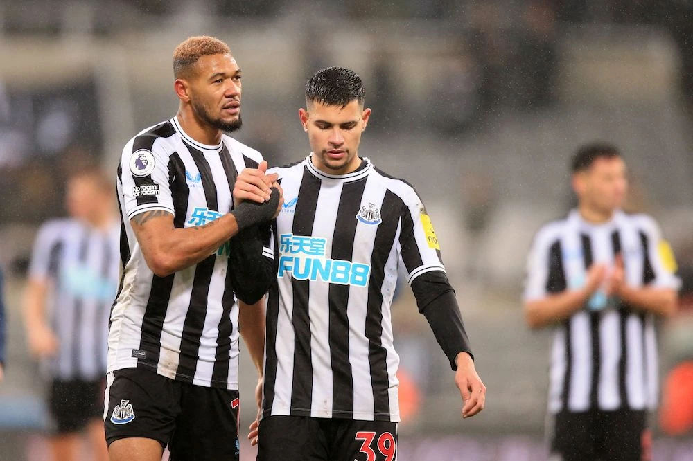 Newcastle United's Brazilian striker Joelinton (L) and Brazilian midfielder Bruno Guimaraes (C) react on the pitch after the English Premier League match between Newcastle and Leeds United. (AFP)