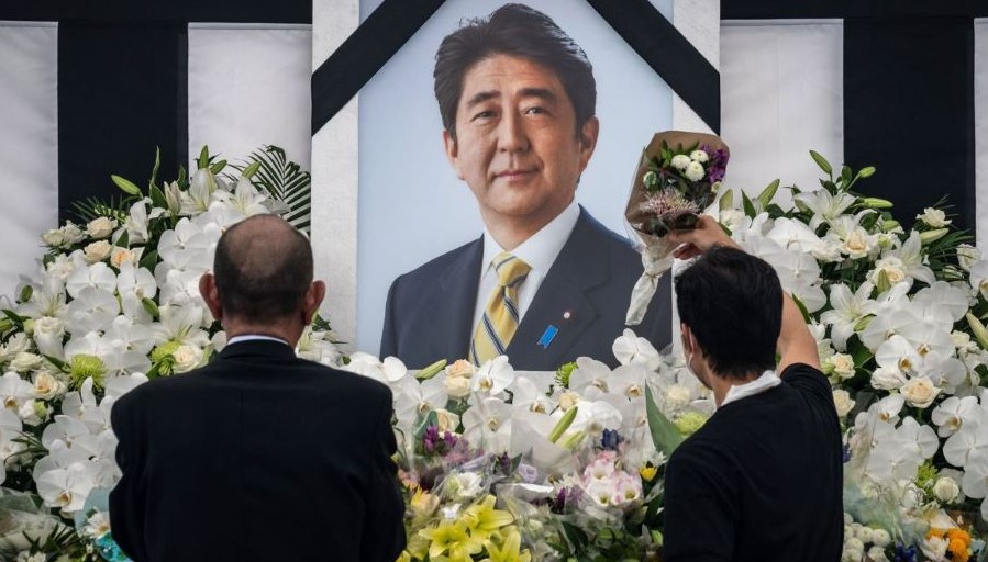 People pay their respects to former Japanese PM Shinzo Abe outside the Nippon Budokan, Tokyo, Japan, Sept. 27, 2022. (AFP)