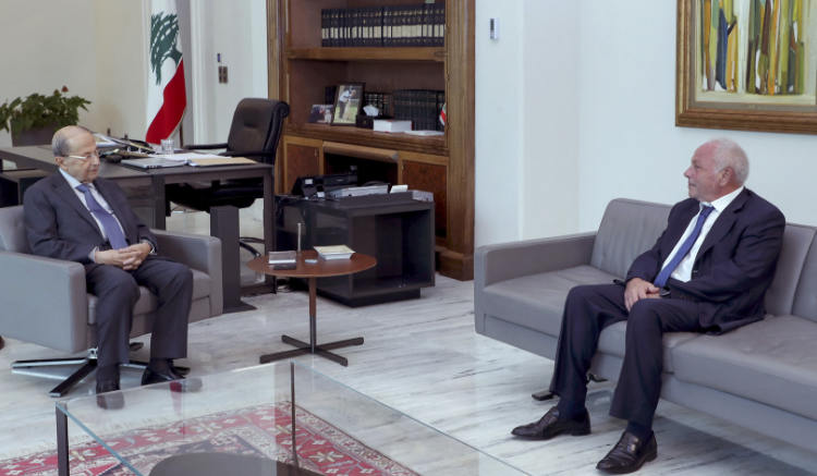 Lebanese Judge Ghassan Ouweidat (R) meeting with President Michel Aoun at the presidential palace of Baabda on July 30, 2021.