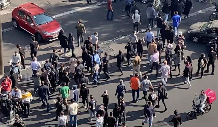 People blocking an intersection during a protest to mark 40 days since the death in custody of Mahsa Amini in Tehran, Iran. (AP)