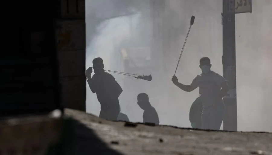 Palestinian demonstrators clash with Israeli troops in the West Bank town of Al-Ram, Jan. 27, 2023. (AFP)