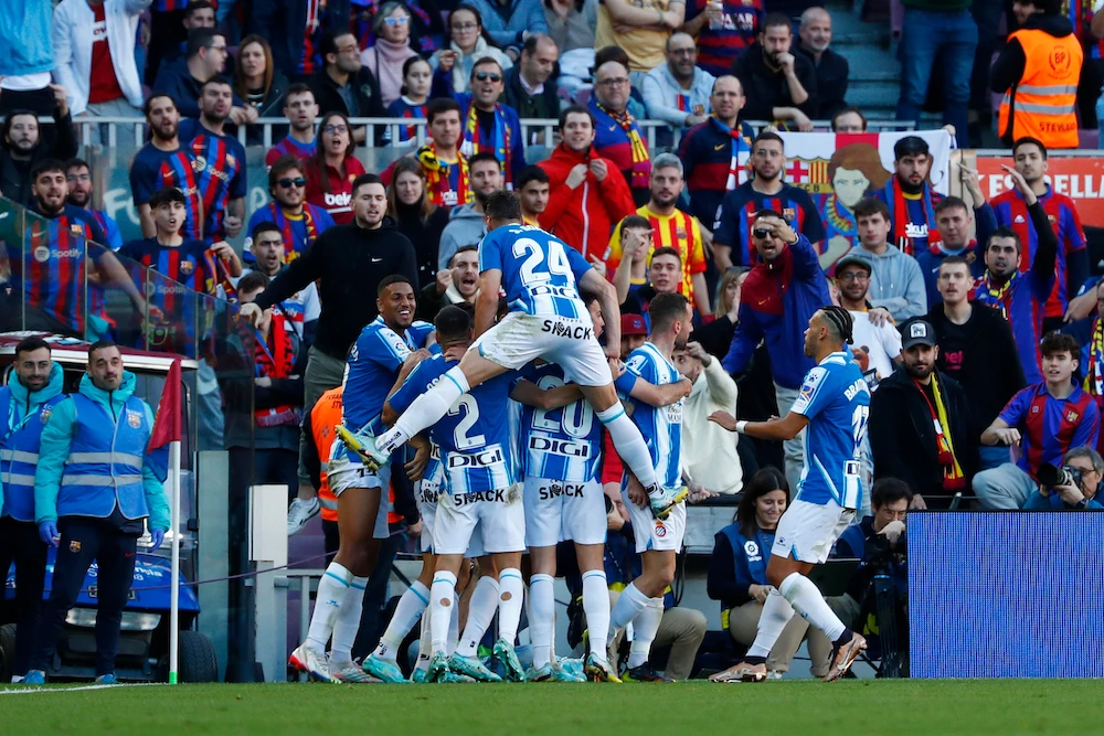 Espanyol players celebrate after Joselu scored during a Spanish La Liga derby match between Barcelona and Espanyol at the Camp Nou stadium in Barcelona Saturday. (AP)
