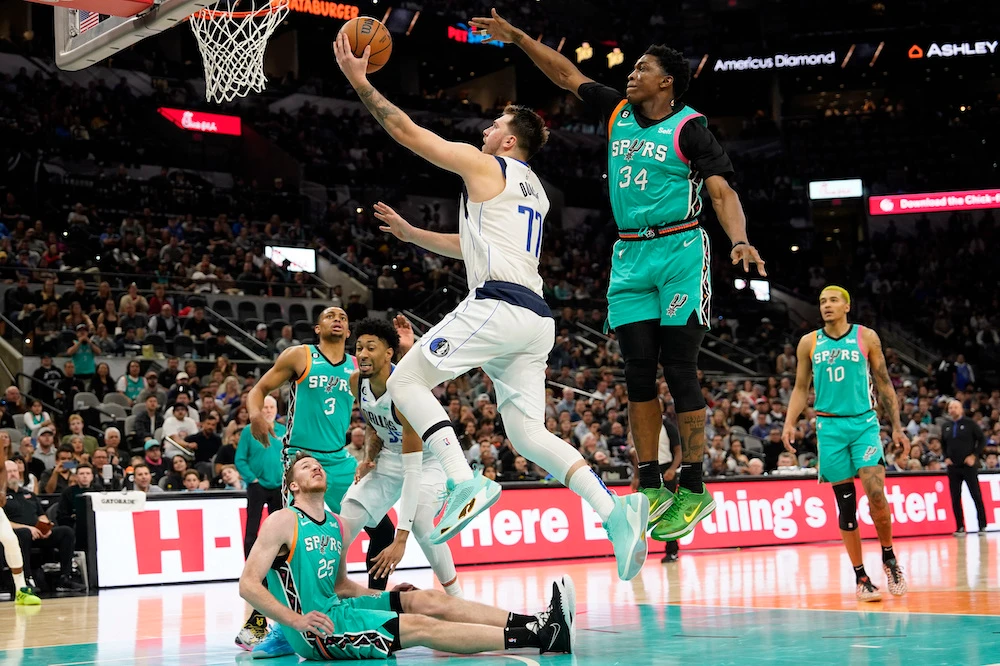 Dallas Mavericks guard Luka Doncic drives to the basket against San Antonio Spurs forward Stanley Johnson (34) during the second half of an NBA game at AT&T Center Saturday. (USA TODAY Sports)