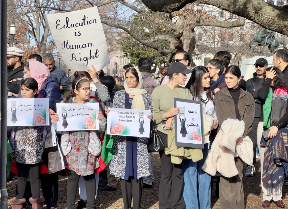 People demonstrate in front of the White House in Washington, DC, on January 1, 2023 against the Afghan Taliban regime's ban of higher education for women. (AFP)