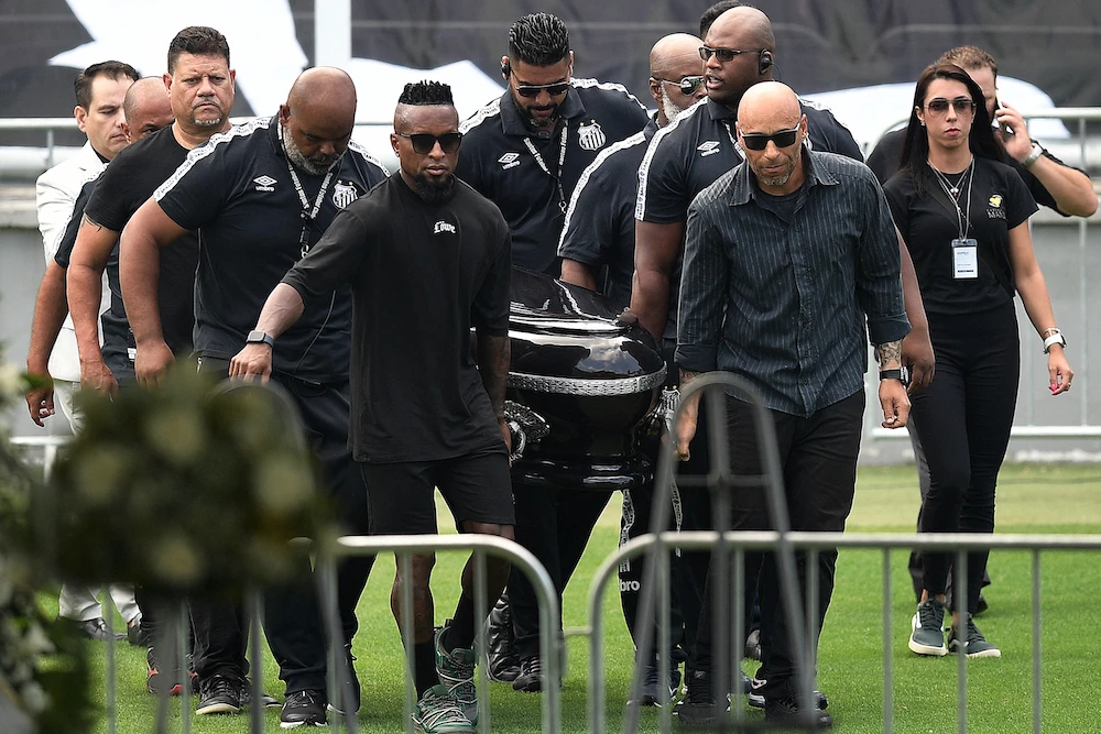 Pallbearers carry the casket of Brazilian soccer legend Pele to the centre circle of his former club Santos' Vila Belmiro stadium where he will lie in state for 24 hours before his funeral (AFP)