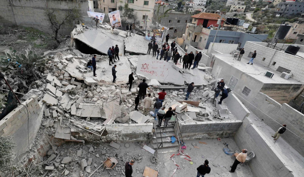 People inspect the rubble of a house that was demolished by Israeli soldiers, in the village of Kafr Dan in Jenin, in the occupied West Bank, on January 2, 2023. (AFP)