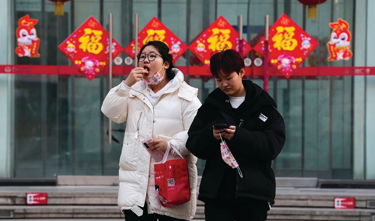 Some people in China’s key cities braved the cold and a spike in COVID-19 infections to return to regular activity on Monday. (AP)