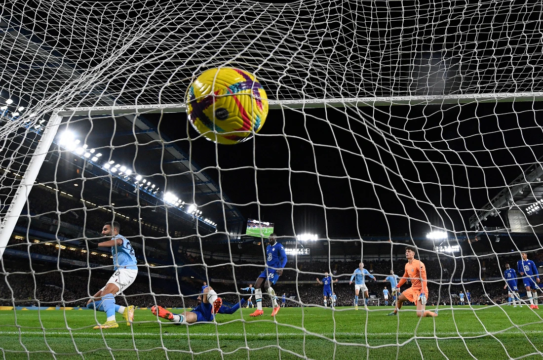 Manchester City's Algerian midfielder Riyad Mahrez (L) celebrates scoring the opening goal during the English Premier League football match between Chelsea and Manchester City. (AFP)