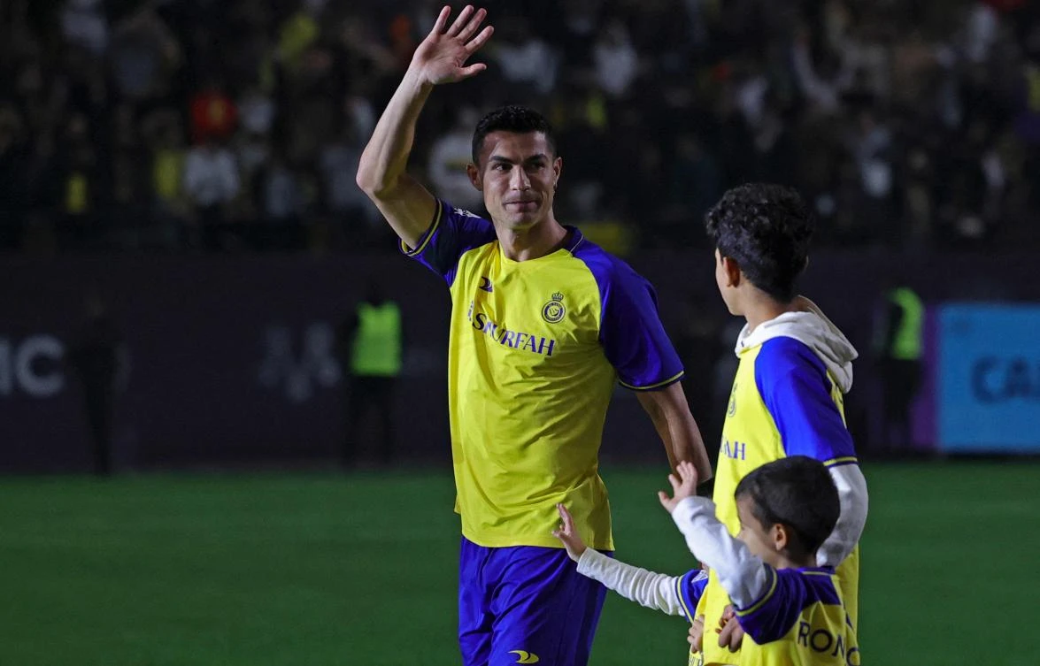 Portuguese forward Cristiano Ronaldo greets the crowd alongside his children at the Mrsool Park Stadium in the Saudi capital Riyadh on January 3, 2023, upon his presentation as an Al-Nassr player. (AFP)