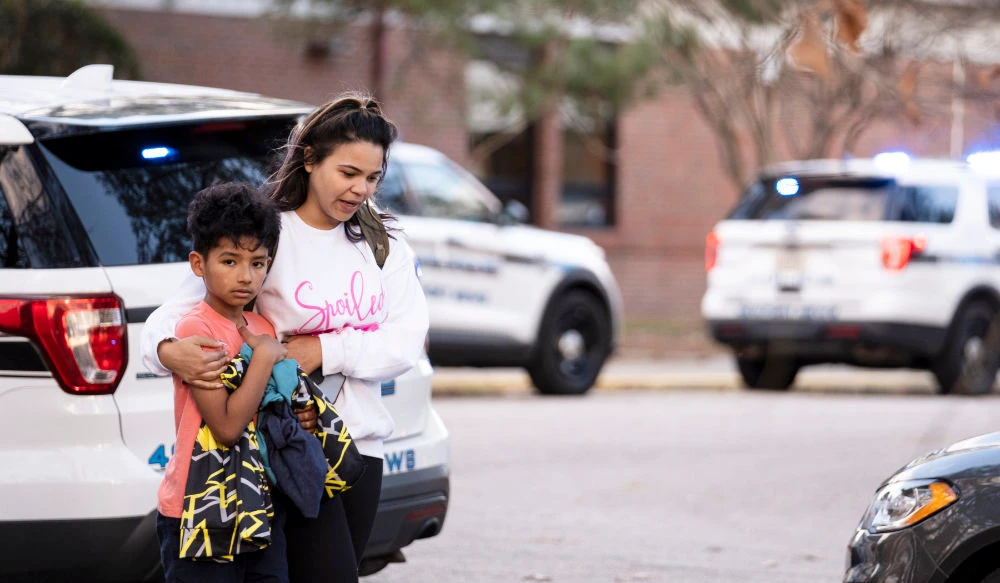 A US fourth grader at Richneck Elementary School is escorted by his mother as they leave the school following a shooting incident on Jan. 6, 2023 in Newport News, Virginia. (AP)