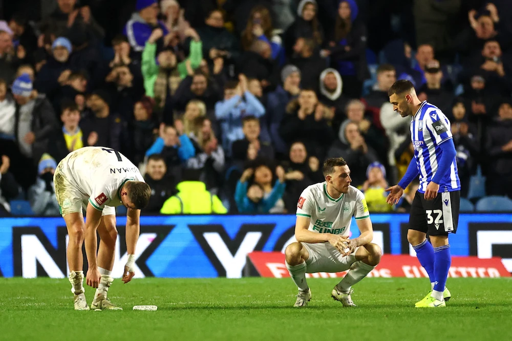 Newcastle United's Chris Wood and Sven Botman look dejected after the defeat to Sheffield Wednesday. (Reuters)