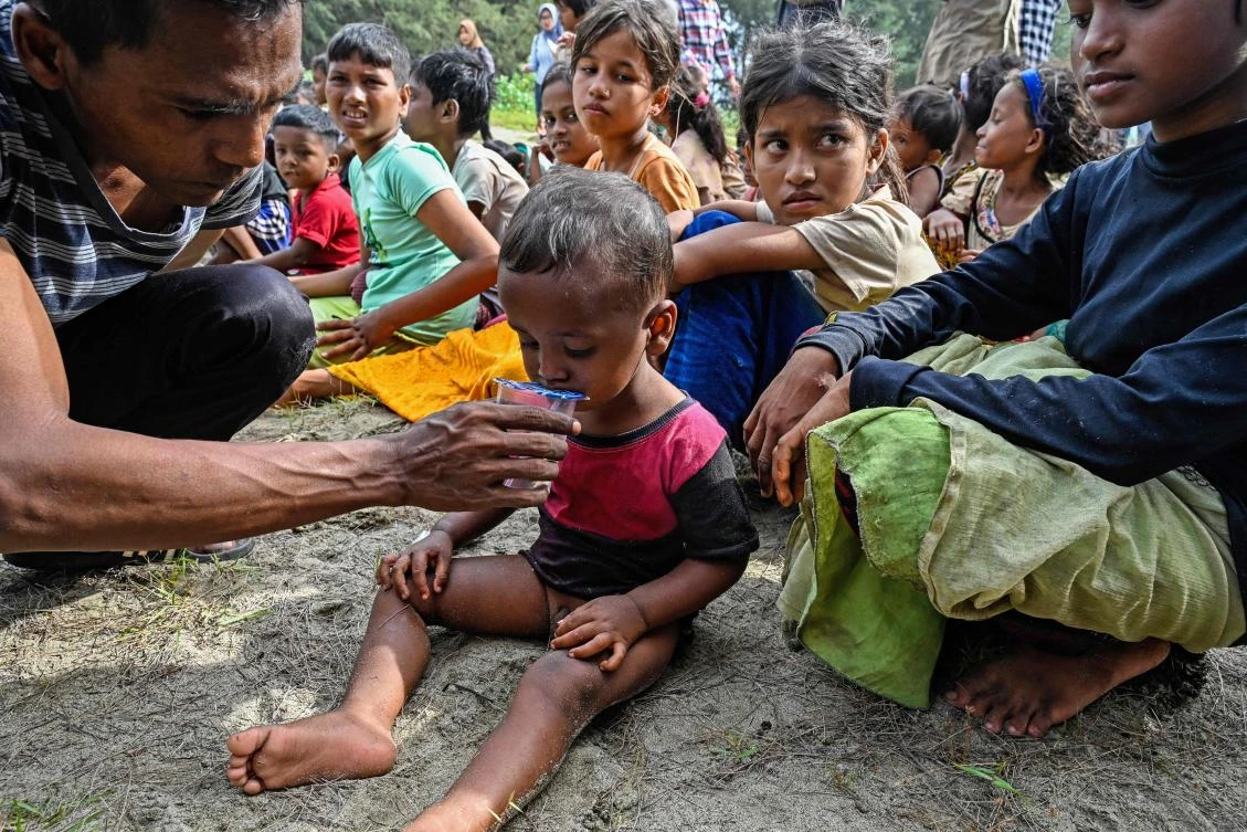 Rohingya refugees gather upon their arrival by a boat in Lamnga beach, Aceh province on January 8, 2023. (AFP)