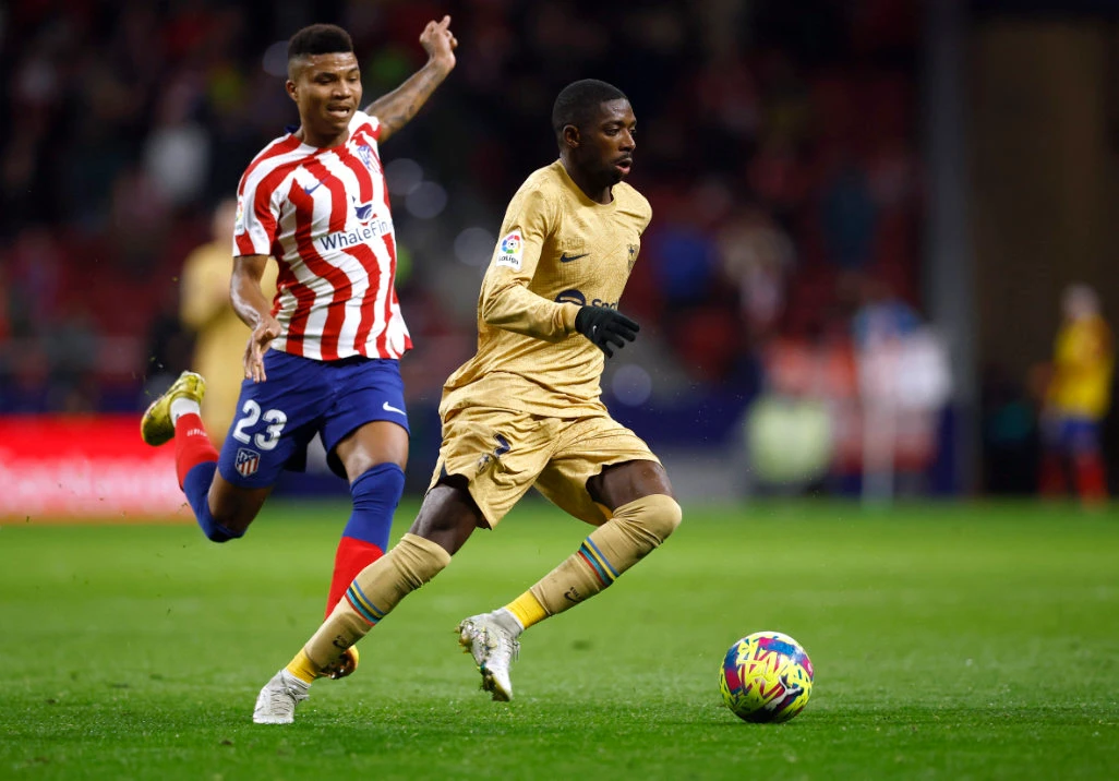 FC Barcelona's Ousmane Dembele in action with Atletico Madrid's Reinildo Mandava during their match. (Reuters)