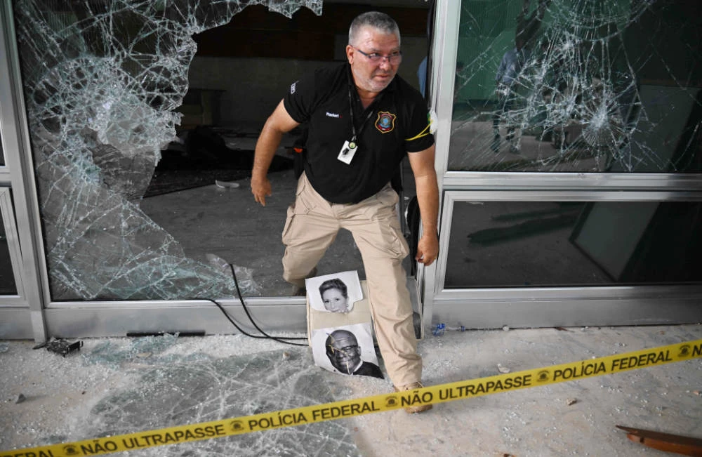 A police officer inspects damages at the Supreme Court building in Brasilia on January 10, 2023, two days after thousands of supporters of Brazil's far-right ex-president Jair Bolsonaro raided federal buildings. (AFP)
