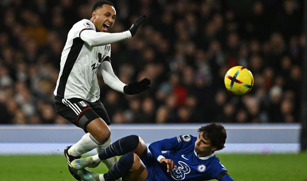 Chelsea's Portuguese striker Joao Felix (R) is sent off for this tackle on Fulham's Dutch defender Kenny Tete during the English Premier League football match between Fulham and Chelsea at Craven Cottage in London on Thursday. (AFP)