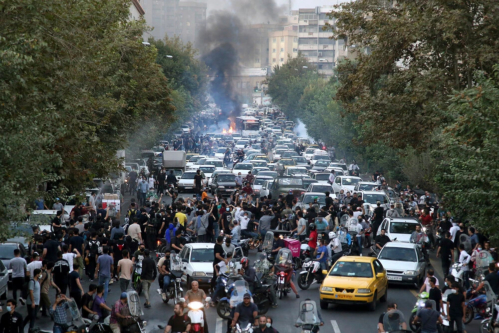 In this photo taken by an individual not employed by AP and obtained by the AP outside Iran, protesters chant slogans during a protest over the death of Mahsa Amini who was detained by the morality police, in downtown Tehran, on Sept. 21, 2022. (AP/File)