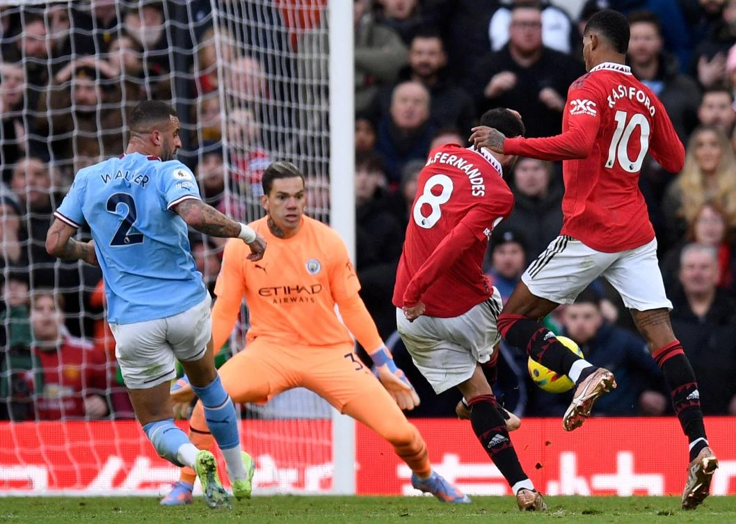 Manchester United’s striker Marcus Rashford watches as midfielder Bruno Fernandes scores the equalising goal past Manchester City's goalkeeper Ederson during their English Premier League match at Old Trafford on Saturday. (AFP)