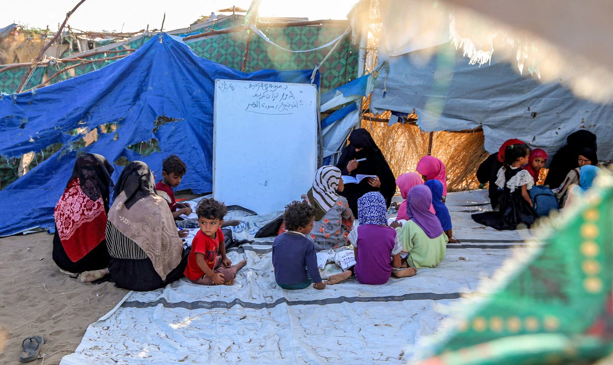 Children attend a class in a tent at a camp for the displaced in the Khokha district of Yemen's western province of Hodeida. (AFP/File)
