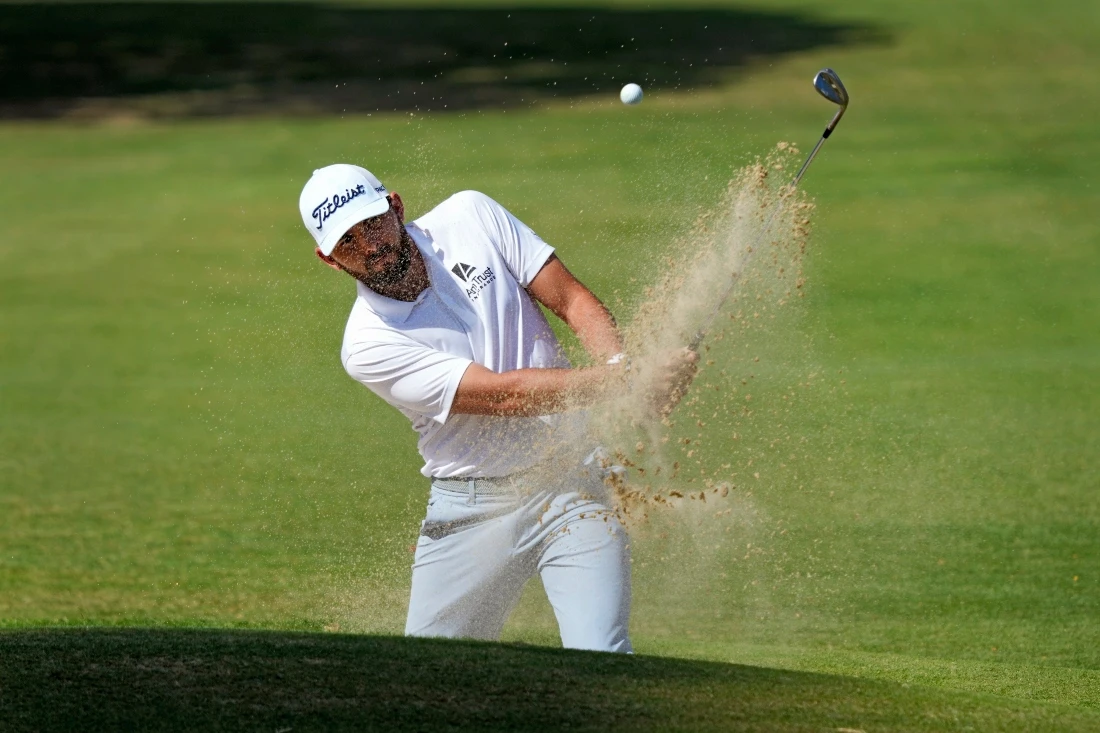 Hayden Buckley hits from the bunker onto the ninth green during the second round of the Sony Open golf tournament Friday at Waialae Country Club in Honolulu. (AP)