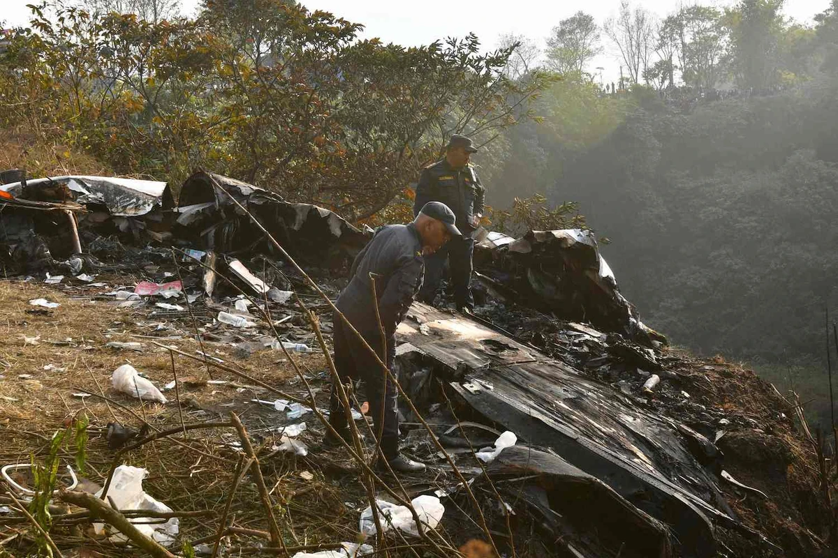 Rescuers inspect the wreckage at the site of a plane crash in Pokhara on January 15, 2023. (AFP)