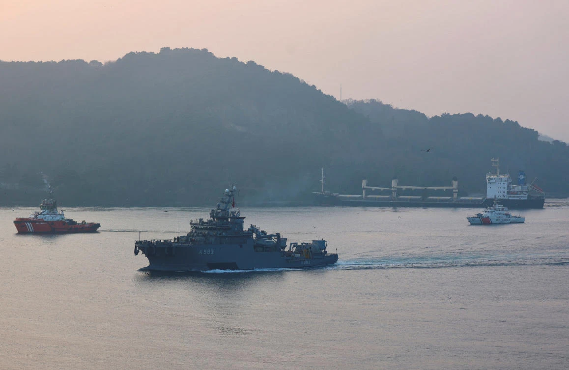 Turkish Navy's rescue ship TCG Isin sails in the Bosphorus as the Palau-flagged bulk carrier MKK1, carrying grain is seen drifted aground in Istanbul (REUTERS)
