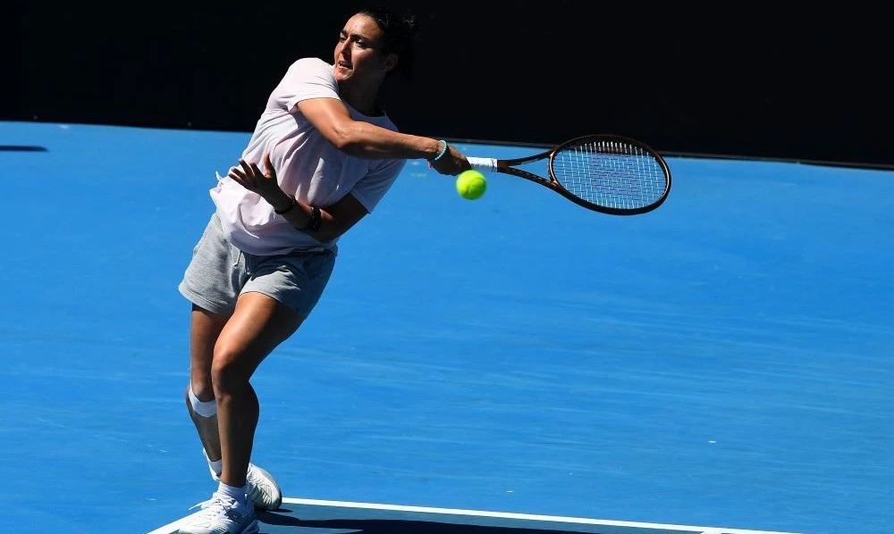Tunisia’s Ons Jabeur hits a return during a practice session ahead of the Australian Open tennis tournament in Melbourne on January 14, 2023. (AFP)
