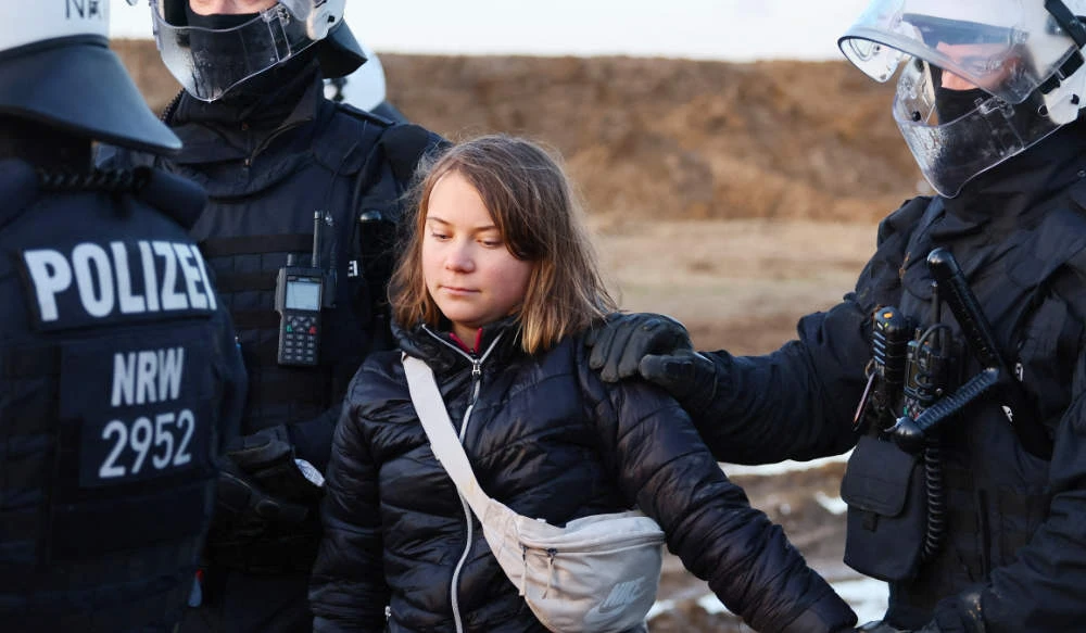 Police officers detain climate activist Greta Thunberg on the day of a protest against the expansion of the Garzweiler open-cast lignite mine of Germany's utility RWE to Luetzerath, in Germany, January 17, 2023 that has highlighted tensions over Germany's climate policy during an energy crisis. (REUTERS)