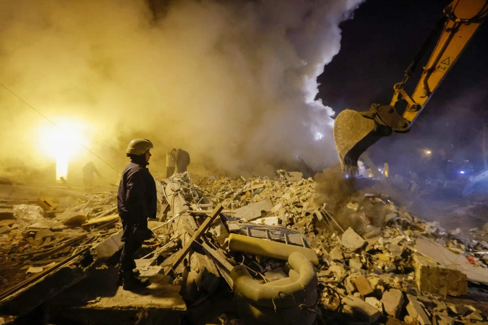 Emergency personnel work among debris at the site where a building was heavily damaged in recent shelling in the course of Russia-Ukraine conflict in Donetsk, Russian-controlled Ukraine, January 16, 2023. (REUTERS)