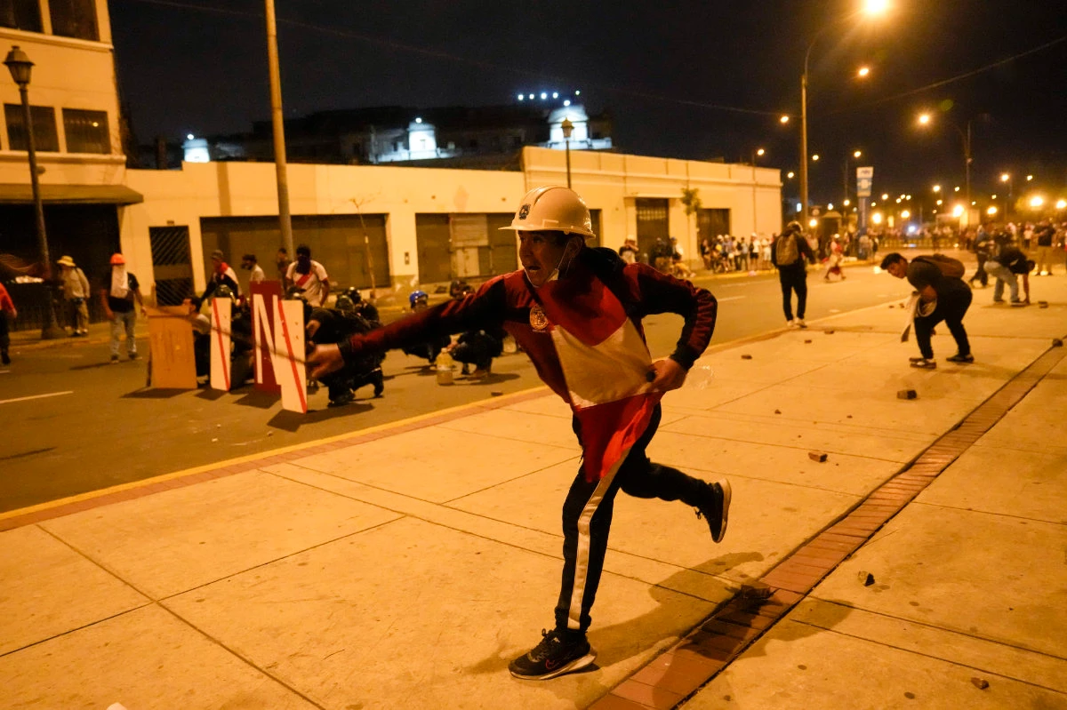 Thousands march on Peru’s capital as unrest spreads, building set ablaze