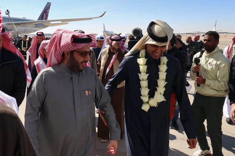 Chairman of Saudi General Entertainment Authority Turki Alalshikh, left, escorts Qatari president of Paris Saint-Germain Nasser Al-Khelaifi on Thursday. (AFP)