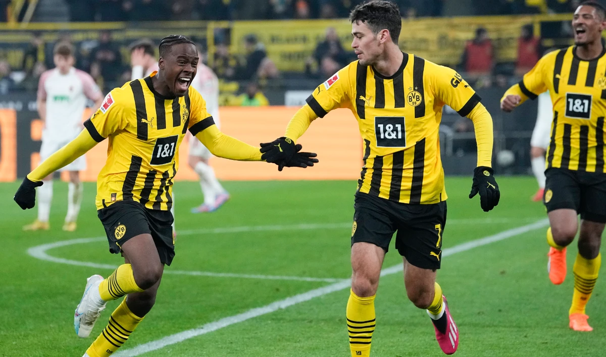 Dortmund's Jamie Bynoe-Gittens celebrates with Giovanni Reyna, second right, and Sebastien Haller, far right, after scoring his side's fourth goal during their German Bundesliga soccer match against FC Augsburg in Dortmund Sunday. (AP)