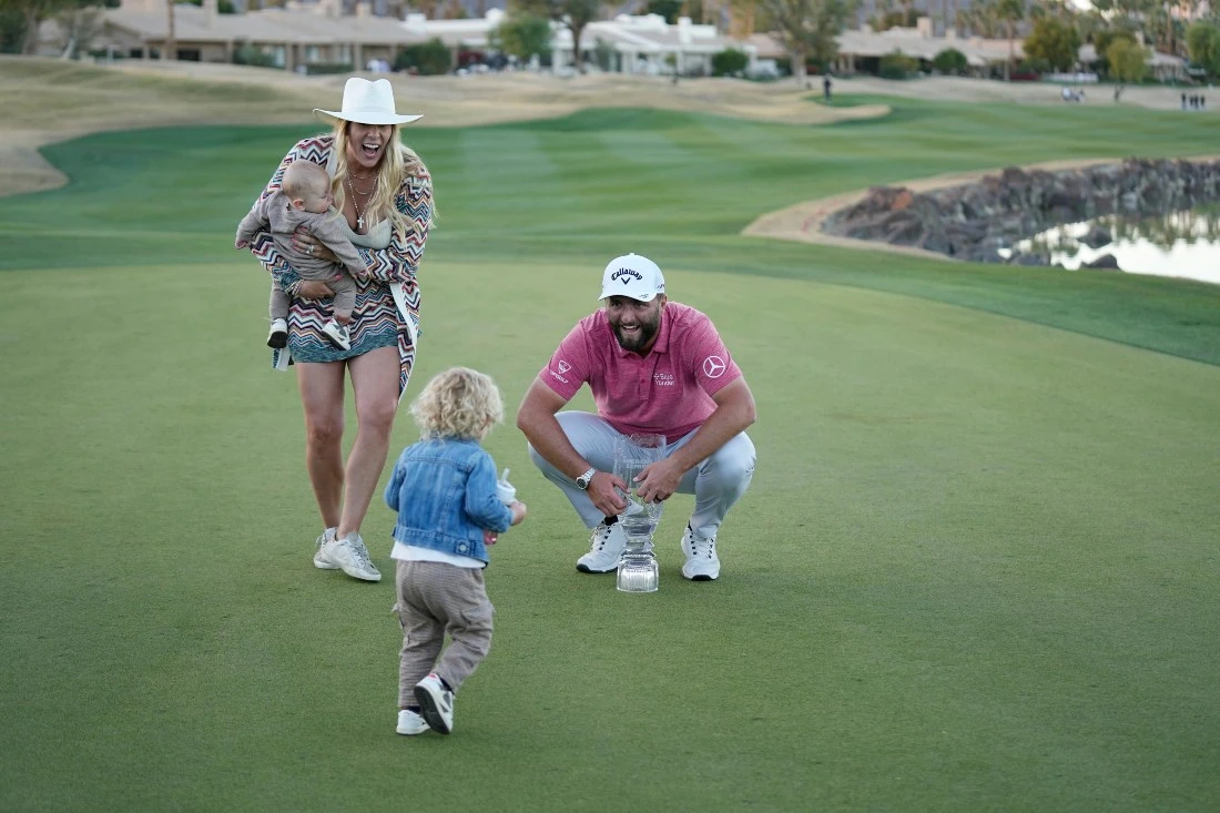 Jon Rahm celebrates with his wife Kelley, left, and sons Eneko, left, and Kepa after winning the American Express golf tournament on the Pete Dye Stadium Course at PGA West Sunday in La Quinta, Calif. (AP)