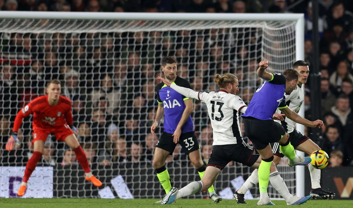 Tottenham Hotspur's English striker Harry Kane shoots to score the opening goal of the English Premier League football match between Fulham and Tottenham Hotspur at Craven Cottage in London on Monday. (AFP)
