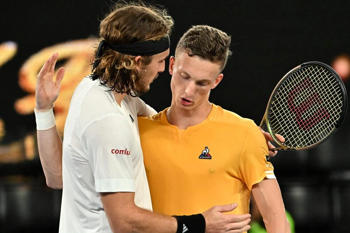 Greece’s Stefanos Tsitsipas embraces Czech Republic’s Jiri Lehecka after the men’s singles quarter-final match on day nine of the Australian Open tennis tournament in Melbourne on January 24, 2023. (AFP)