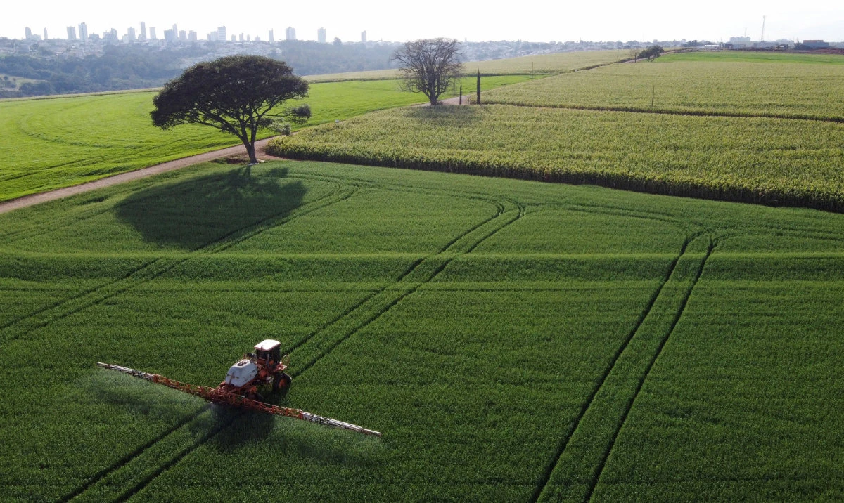 A tractor sprays pesticides on wheat crops, in Arapongas, Brazil. (Reuters)