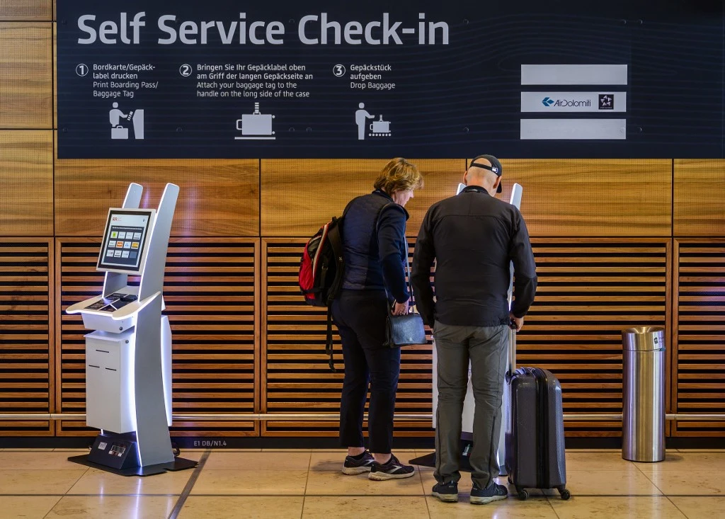 Passengers use a self-service check-in kiosk at Berlin Brandenburg International airport's terminal 1 (AFP)