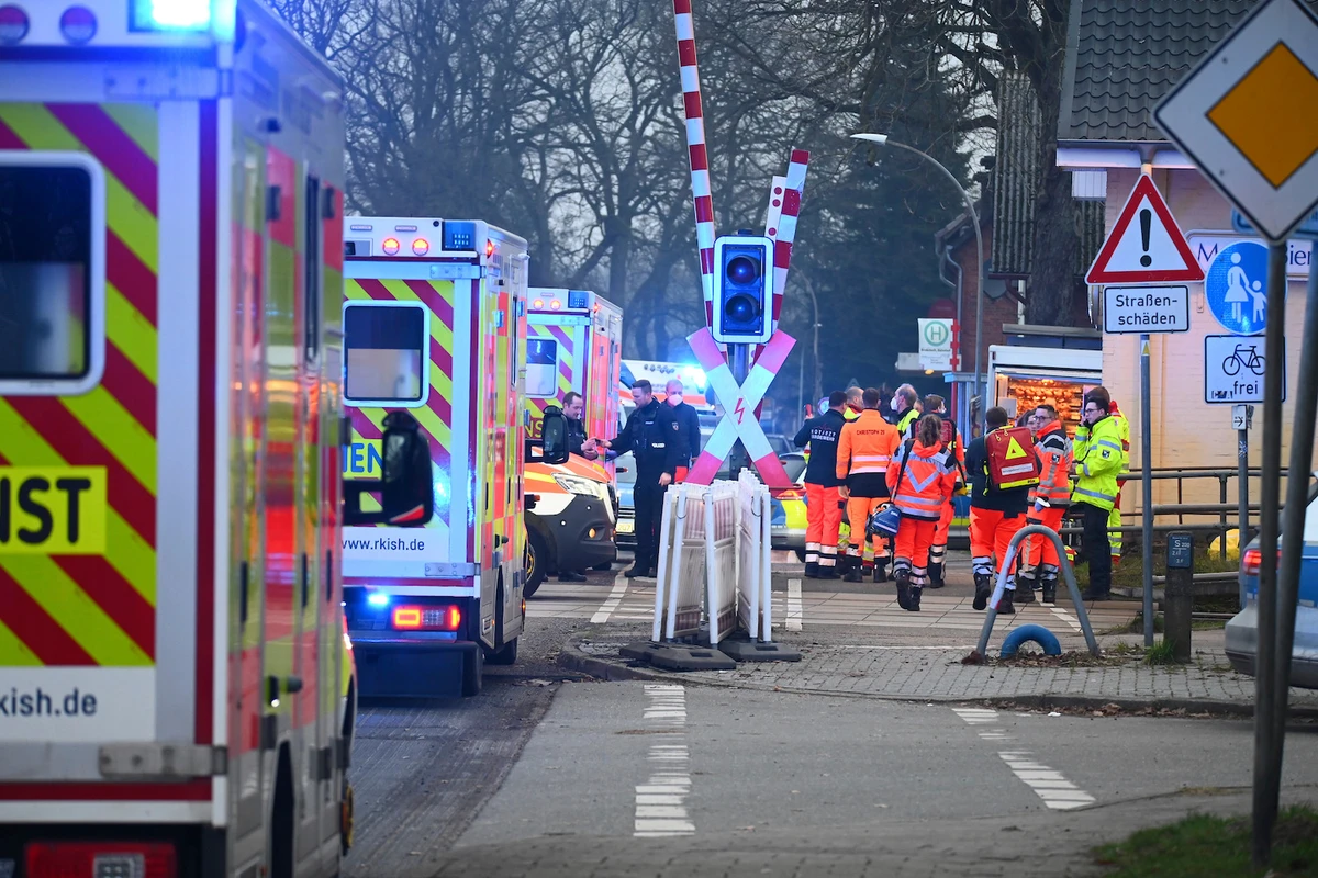Police and rescue services are on duty at a level crossing near Brokstedt station in Brockstedt, Germany, Wednesday, Jan. 25, 2023. (AP)