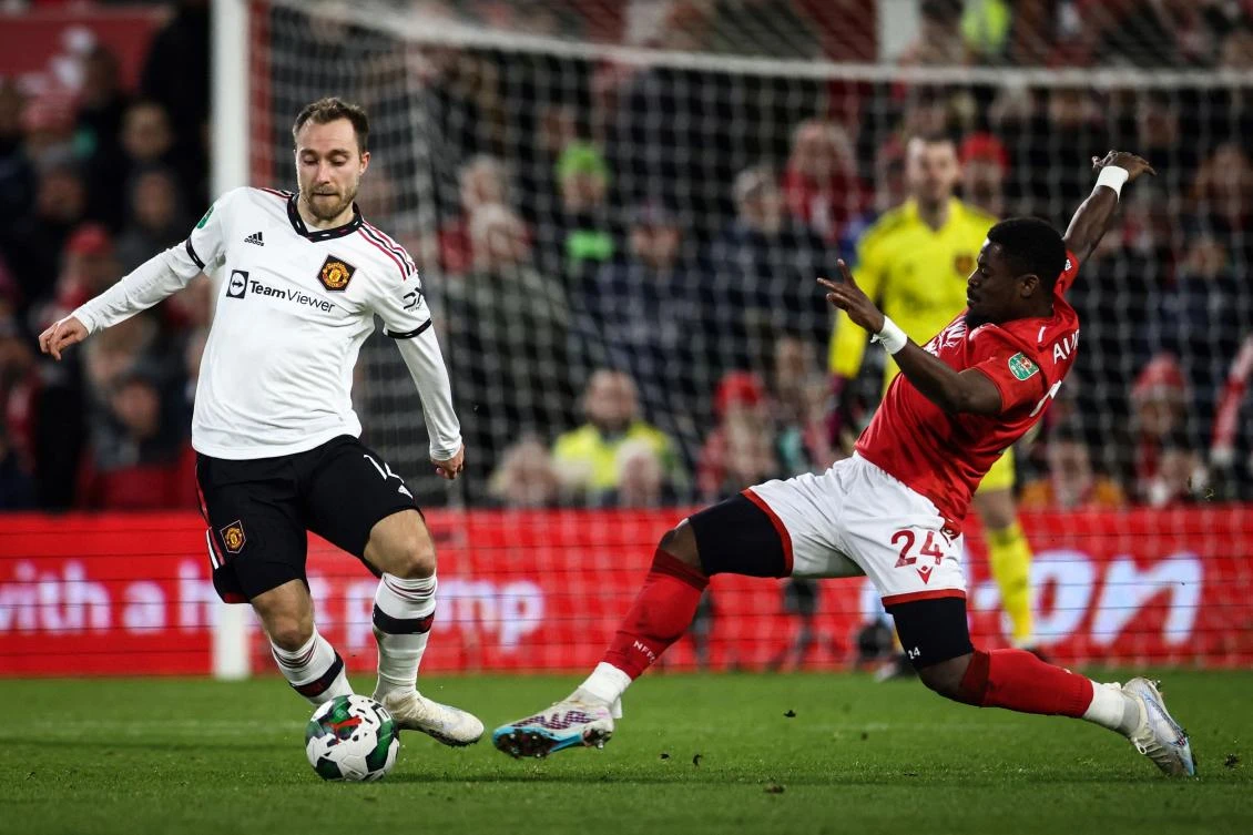 Manchester United’s midfielder Christian Eriksen fights for the ball with Nottingham Forest’s defender Serge Aurier during their English League Cup semifinal first-leg match, at The City Ground stadium, in Nottingham on Jan. 25, 2023. (AFP)